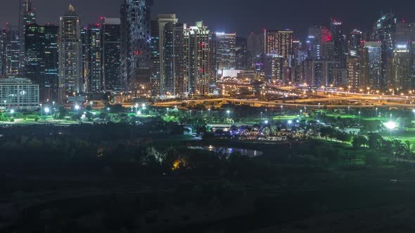 Jumeirah Lake Towers and Dubai Marina Skyscrapers and Golf Course Night Timelapse Dubai United Arab alt