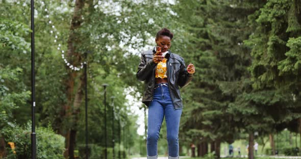 Woman with Headphones Dancing alt