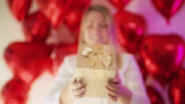 Close Up Golden Glittery Gift Box in Slow Motion Woman with Elegant Luxury Gift alt