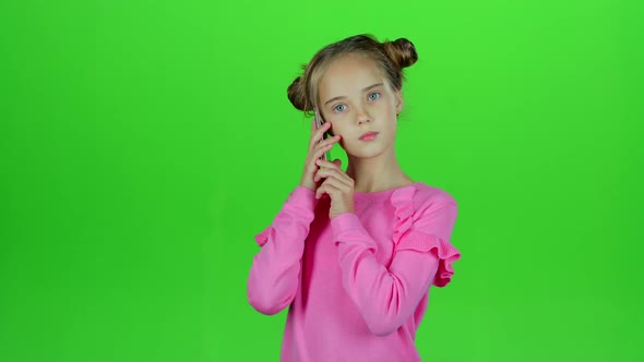 Baby Is Talking on the Phone with Her Mom. Green Screen alt