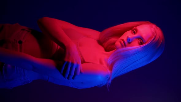 Beautiful Stylish Woman Model Posing in Neon Light alt