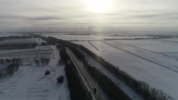  Aerial View on the Highway in Endless, Snowy Fields