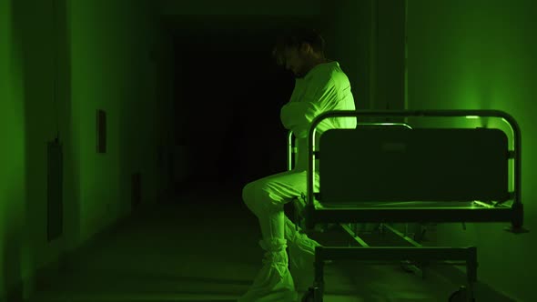 A Mad Male Patient in Straitjacket is Going Crazy in a Mental Hospital alt
