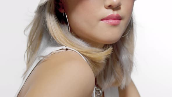 Tilted Up Portrait of Blonde Korean Model with Fresh Natural Makeup Wearing a Bucket Hat