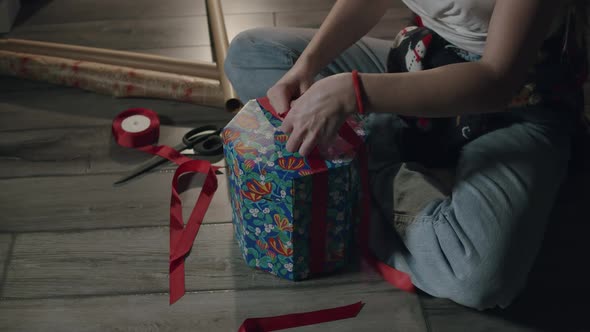 Woman Packing Xmas Fancy Gift at Home