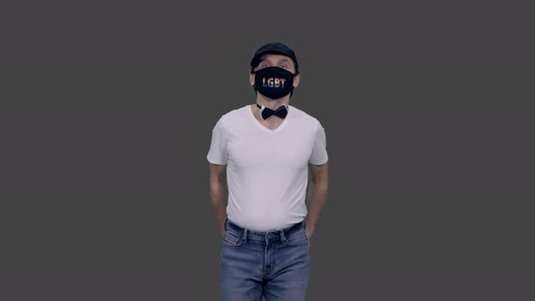 Gay Man in Bow Tie and Anti Covid Lgbt Mask Walking with Hands in Pockets, Alpha in