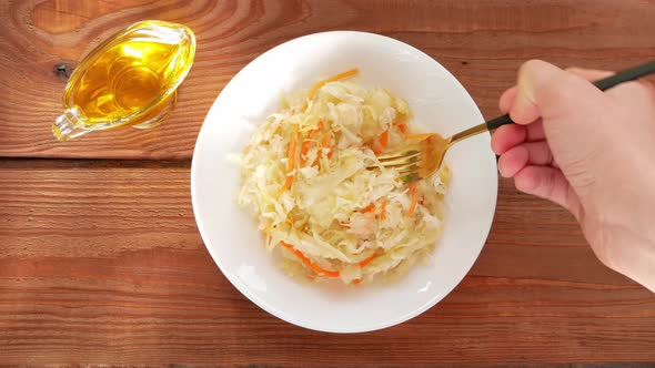 Sauerkraut on white plate wooden table. Pickled cabbage carrot Fermented by lactic acid vegetables alt