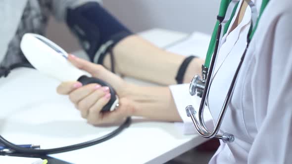 Female Doctor Measures A Patient's Blood Pressure