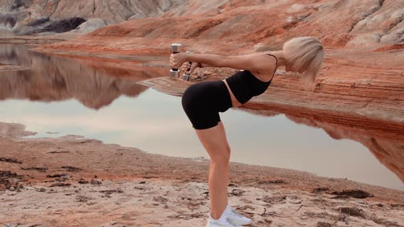 Woman working out on lifeless dried locality