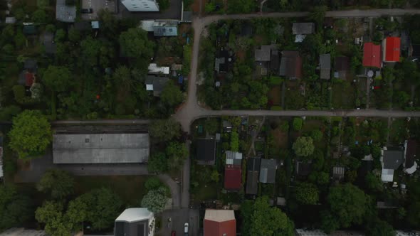 Aerial Birds Eye Overhead Top Down Panning View of Low Houses in Ruegen Allotment Gardens alt