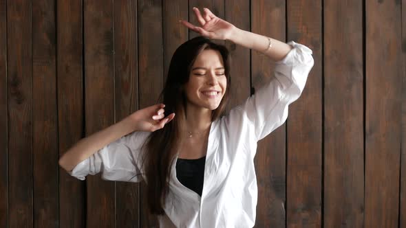 Portrait of a happy young woman dancing