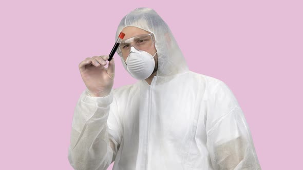 Medical Worker in Protective Clothing Exploring Blood Test Capsule Tube alt