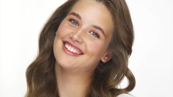 Portrait of Beautiful Girl with Natural Healthy Hair and Light Make-up on White alt