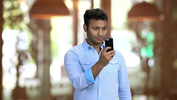 Brownskinned Office Worker Taking Photos of Someone Unnoticeably alt