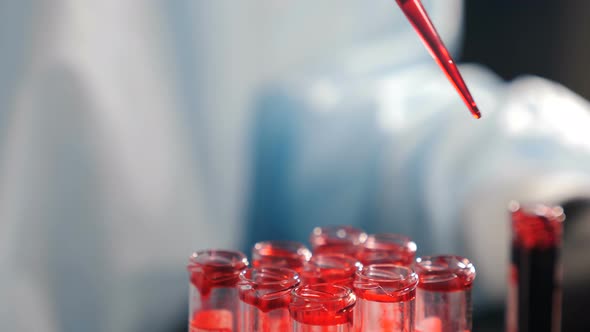 Biochemistry Medical Laboratory Research Lab Specialist Working with Pipette and Test Tubes alt