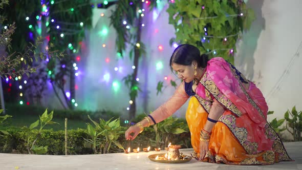 A Women Lighting a Lamp