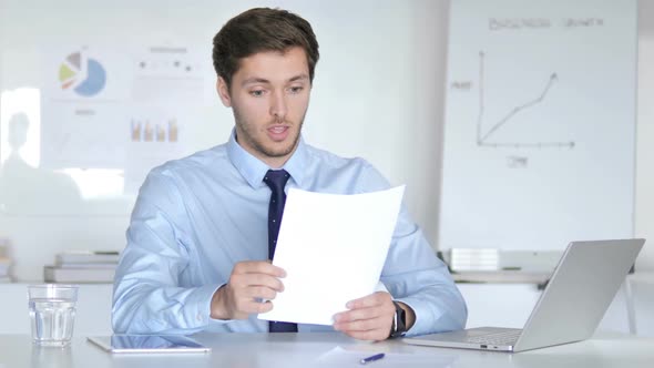Happy Businessman Cheering New Contract Reading Documents alt