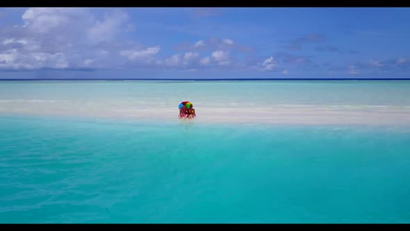 Man and woman sunbathing on luxury coast beach lifestyle by clear water and white sand background of alt