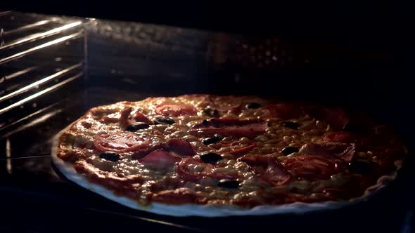 View from inside of the oven. Cooking italian pizza in electric convection oven. Closeup of pizza  alt