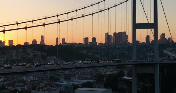 Istanbul Bosphorus Bridge and City Skyline in Background with Turkish Flag at Beautiful Sunset alt