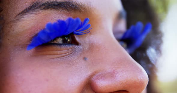 Woman in blue eye lashes at music festival 4k alt
