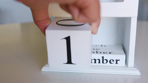 Boy Flips Handmade Wood Cubes with Date Day 11 November US Veterans Day alt