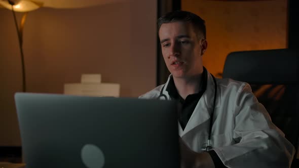 Doctor Talks About Treating a Patient Through an Online Conference Call on a Laptop alt