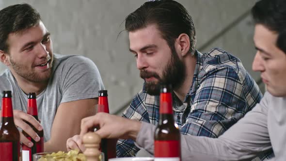 Male Friends Drinking Beer and Chatting alt