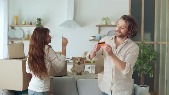 Happy Couple Feeling Satisfaction of Shopping Online with a Credit Card at Home alt