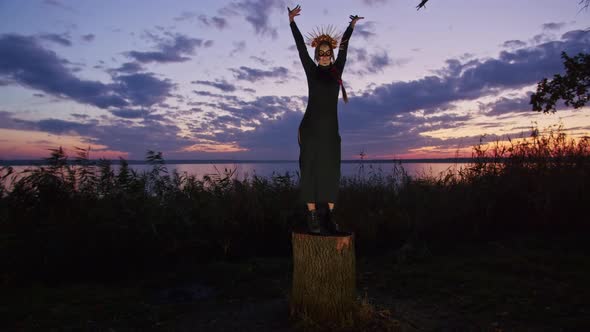 Happy Young Woman in Halloween Costume and Makeup Dances in Nature During Sunset Mystical Footage alt