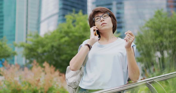 Woman Speaks By Smartphone alt