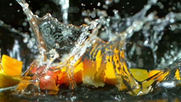 Super Slow Motion Shot of Falling and Splashing Mango Slices Isolated at 1000Fps. alt