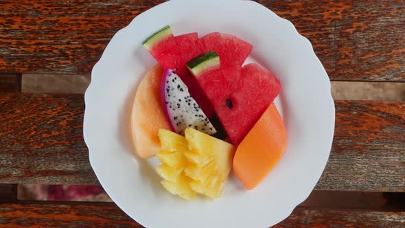 View From Above of a White Plate Full of Delicious Ripe Sweet and Fresh Exotic Sliced Fruits Mango
