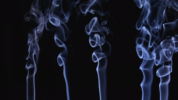White Smoke Floating in Space on a Black Background in Slow Motion alt