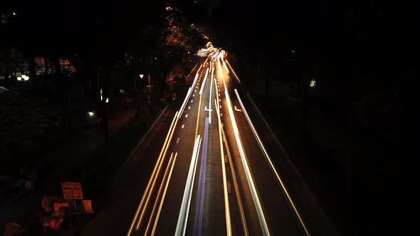 Time lapse of night traffic, cars and motorbikes driving on road in Ho Chi Minh city. Car headlights