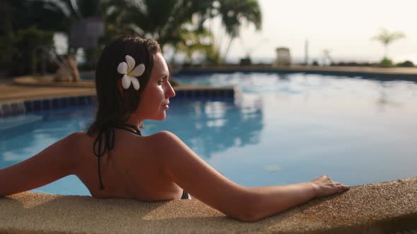 Caucasian Woman Sitting in Resort Swimming Pool