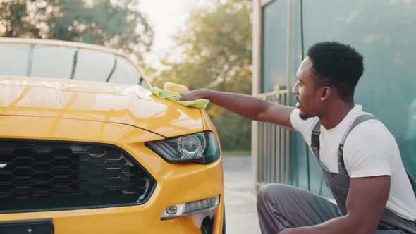 Portrait of a Smiling Young African American Man in Gray Overalls and White alt