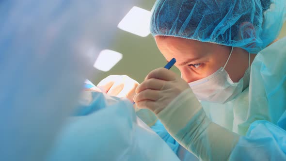 Surgeon Woman Performs Surgery on Patient