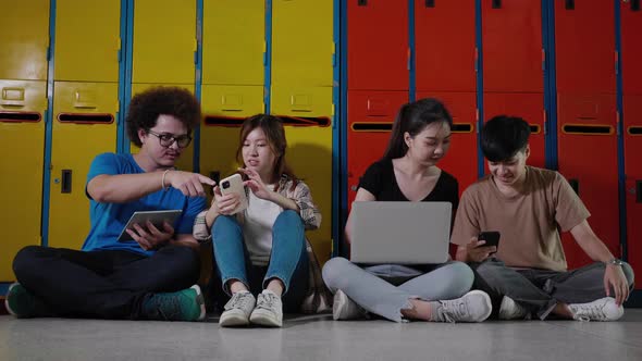 Students with digital tablet, smartphone, computer laptop in in college. Technology and education alt