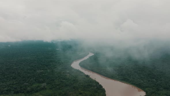Foggy Clouds Revealed Tropical Rainforest And Amazon River In Ecuador. Aerial Drone Shot alt