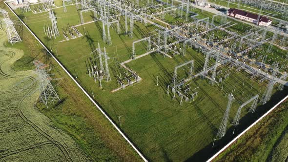 Power plant with tall pylons and voltage distribution cables. alt