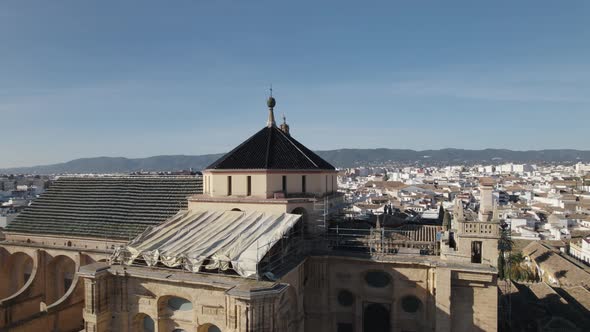 Half aerial orbit around top parts of Mosque-Cathedral of Cordoba, Spain