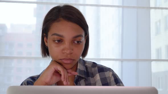 A Woman Looks at the Laptop