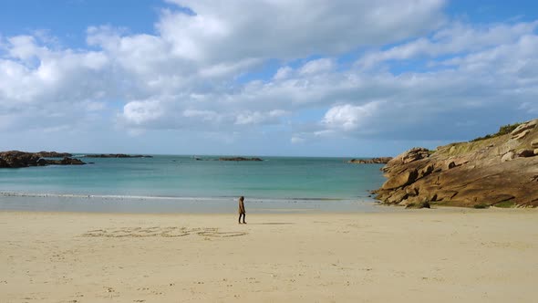 Girl Walking By The Empty Beach alt