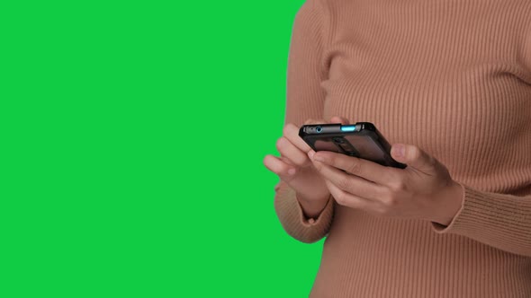 Asian woman hand using smartphone on chroma key green screen background. Alpha Channel.