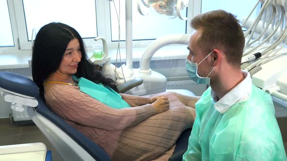 Dentist and His Client Show Their Thumbs Up alt