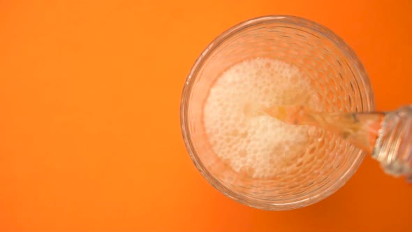 Pouring Carbonated Lemonade in the Glass From Top View