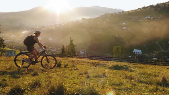 Family Couple of Cyclists Riding in the Mountains alt