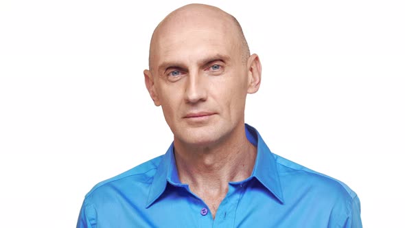 Bold Confident Caucasian Middleaged Male in Blue Shirt Standing on White Background Looking at alt