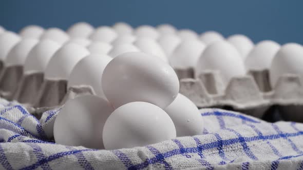 Lots of Fresh Raw Chicken Eggs in a Cardboard Box Rotating Shot Chicken White Fresh Raw Eggs on a alt